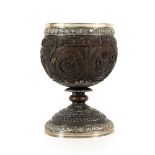 A George IV Silver Mounted Coconut Cup, the silver London 1822, of ovoid form, carved with various