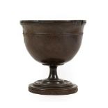 A Lignum Vitae Pedestal Cup, 18th century, the ovoid bowl with reeded rim and turned band on a