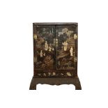 A Chinese Kangxi Lac Burgaute Two-Door Cabinet, inlaid in mother-of-pearl with figures in landscape,