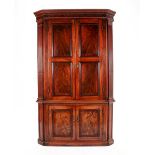 A George III Mahogany Free-Standing Corner Cabinet, Early 19th Century, the moulded cornice above