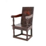 A 17th Century Joined Oak and Carved Wainscot Armchair, bearing Journeyman stamp RS, the back