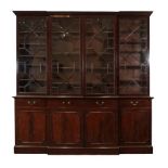 A George III Mahogany Breakfront Library Bookcase, early 19th century, the dentil cornice above