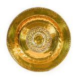 A Nuremberg Brass Alms Dish, 17th century, the central gadrooned boss within foliate bands,