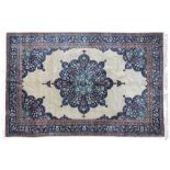 Indian Carpet, 2nd half 20th century The plain cream field with indigo flower head medallion