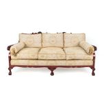 A 1920's Red Japanned Three-Seater Bergère Sofa, the single cane back support with carved shells,