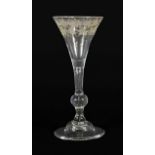 A Wine Glass, 1740, the drawn trumpet bowl engraved with fruiting vine on a baluster stem, basal