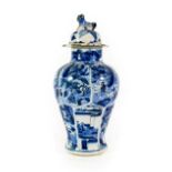 A Chinese Porcelain Vase, Kangxi, of lappet moulded baluster form, painted in underglaze blue with