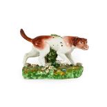 A Derby Porcelain Figure of a Hound, circa 1790, on a mound base, 16.5cm long. Restoration to