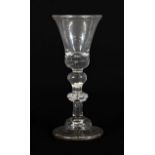 A Wine Glass, circa 1730, the bell shaped bowl with air tear to solid base, on an inverted