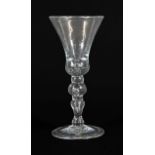 A Wine Glass, circa 1730, the thistle shaped bowl with air tear to solid base, on a ball knopped