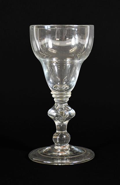 A Large Wine Glass, circa 1710, the ogee bowl on triple collar stem with cushion knop and ball