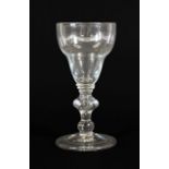 A Large Wine Glass, circa 1710, the ogee bowl on triple collar stem with cushion knop and ball