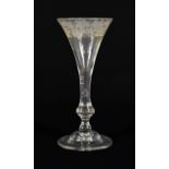 A Wine Glass, 1740, the drawn trumpet bowl engraved with fruiting vine on a baluster stem, basal