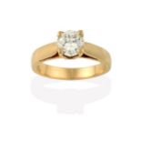 A Diamond Solitaire Ring, the round brilliant cut diamond in a yellow four claw setting, to a