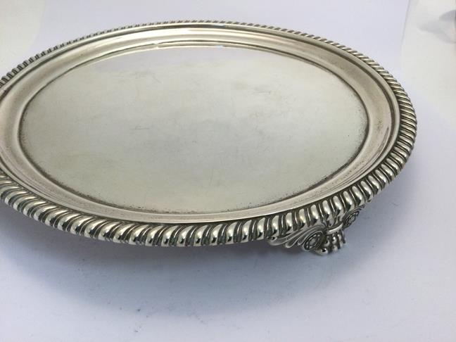 A George III Silver Salver, by John Mewburn, London, 1824, circular and on three scroll and paw cast - Image 5 of 5