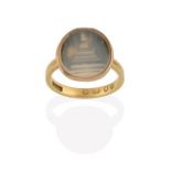 An 18 Carat Gold Victorian Agate Ring, the oval banded grey agate plaque depicting a stepped