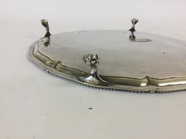 A George III Silver Salver, Probably by John Carter, London, 1774, shaped circular and on four - Image 3 of 5