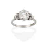 A Diamond Solitaire Ring, the round brilliant cut diamond to old cut diamond set stepped