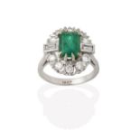 An Emerald and Diamond Cluster Ring, the emerald-cut emerald within a border of round brilliant