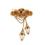 A Victorian Garnet and Ivory Brooch, the yellow trefoil scrolled ribbon bow motif set throughout