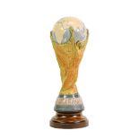 Lladro Model Of The Fifa World Cup designed by Bertoni of Italy, raised on turned wooden plinth,