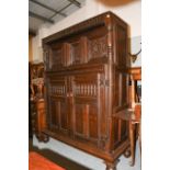 A 17th century oak court cupboard with foliate carved panel doors and turned supports, with