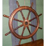 ~A brass mounted ships wheel, 136cm diameter. Some handles have been replace, one repaired with a