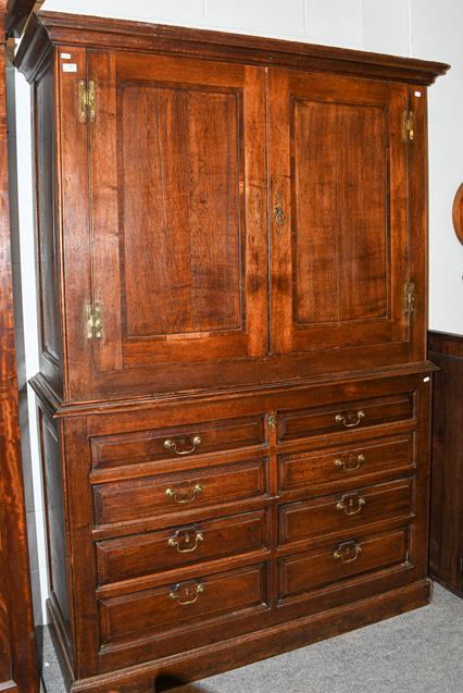 An 18th century oak press cupboard (alterations), 144cm by 55cm by 205cm. This piece has been