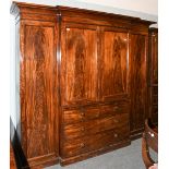 A 19th century mahogany triple wardrobe, 245cm by 65cm by 214cm. A few superficial scrapes to the