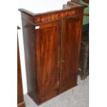 A Mahogany Wall Cabinet, 2nd quarter 19th century, with two panel doors enclosing an arrangement