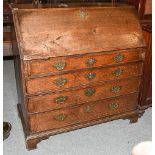 A George III oak bureau with fitted interior raised on a four-height chest base on bracket supports,