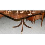 A Regency mahogany snap-top breakfast table raised on reeded sabre supports with brass claw castors,