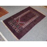 An Afghan Baluch rug the field with columns of barber poles beneath the Mihrab enclosed by triple