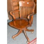 ~ An early 20th century mahogany framed slat back office chair