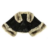 Modern Shaved Astracan and Chinchilla Trimmed Capelet, with hook and eye fastening. Appears in