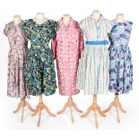 Circa 1950s Cotton Printed Day Dresses, comprising a pink, green and blue floral dress, buttons to