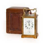 A brass carriage clock alarm timepiece in travelling case