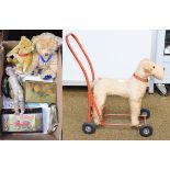 A box of vintage lace and linen, a child's push along straw filled dog, a bisque head doll Alma 9/0,