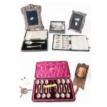 A collection of assorted silver, including: two photograph frames; a cased set of silver and