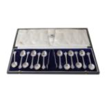 A cased set of twelve George V silver teaspoons with a pair of tongs en suite, by The Goldsmiths and