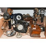 Four 1920s stick telephones, together with three bell boxes, another Bakelite telephone, and a