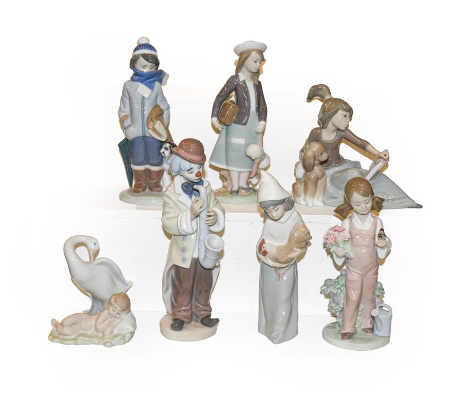 Eight Lladro figures including a clown playing a saxophone