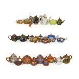 A collection of Chinese and Japanese miniature teapots including Cloisonne, Satsuma, Blanc de