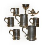 An 18th century pewter communion cup, an American pewter oil lamp, and assorted 18th century