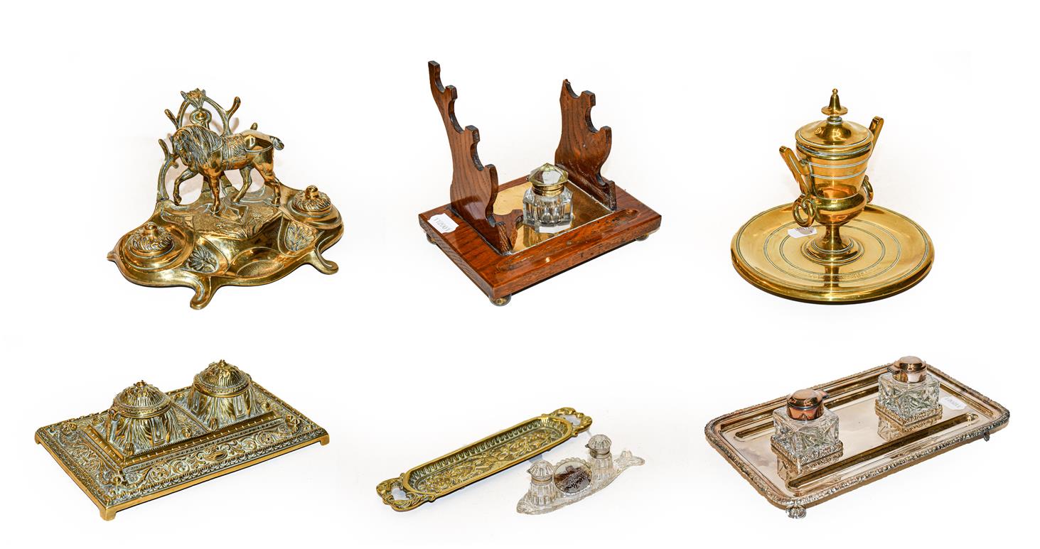 Two trays of assorted desk stands, including a brass equestrian theme example, a silver plated stand