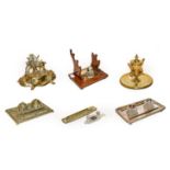 Two trays of assorted desk stands, including a brass equestrian theme example, a silver plated stand