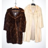 A white mink three quarter length coat, and a dark mink jacket cut with chevron stripes (2)
