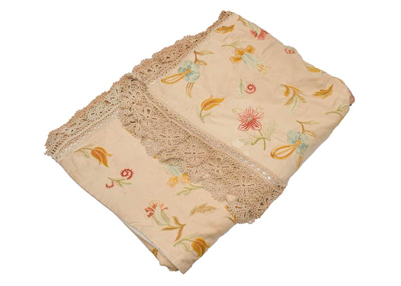 A large crewel work hanging/bedspread woven with floral motifs in wool within a crochet trim,