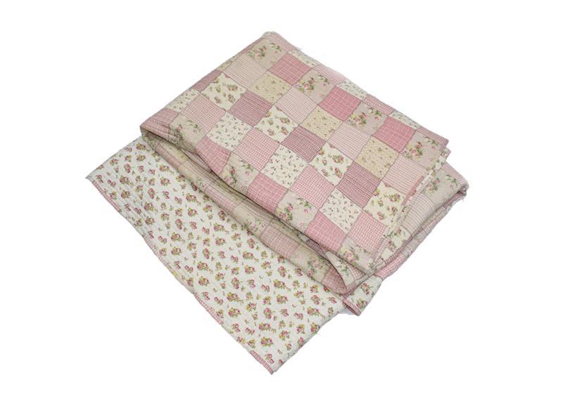 A 20th century pink floral patchwork quilt, comprising squares of pink checks, stripes and floral