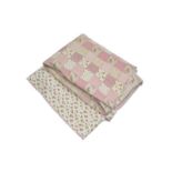 A 20th century pink floral patchwork quilt, comprising squares of pink checks, stripes and floral